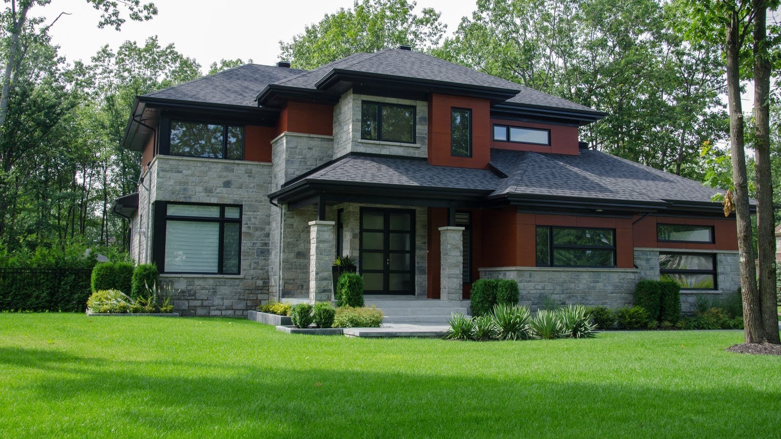 Custom craftsman home with stone veneer and warm evening light