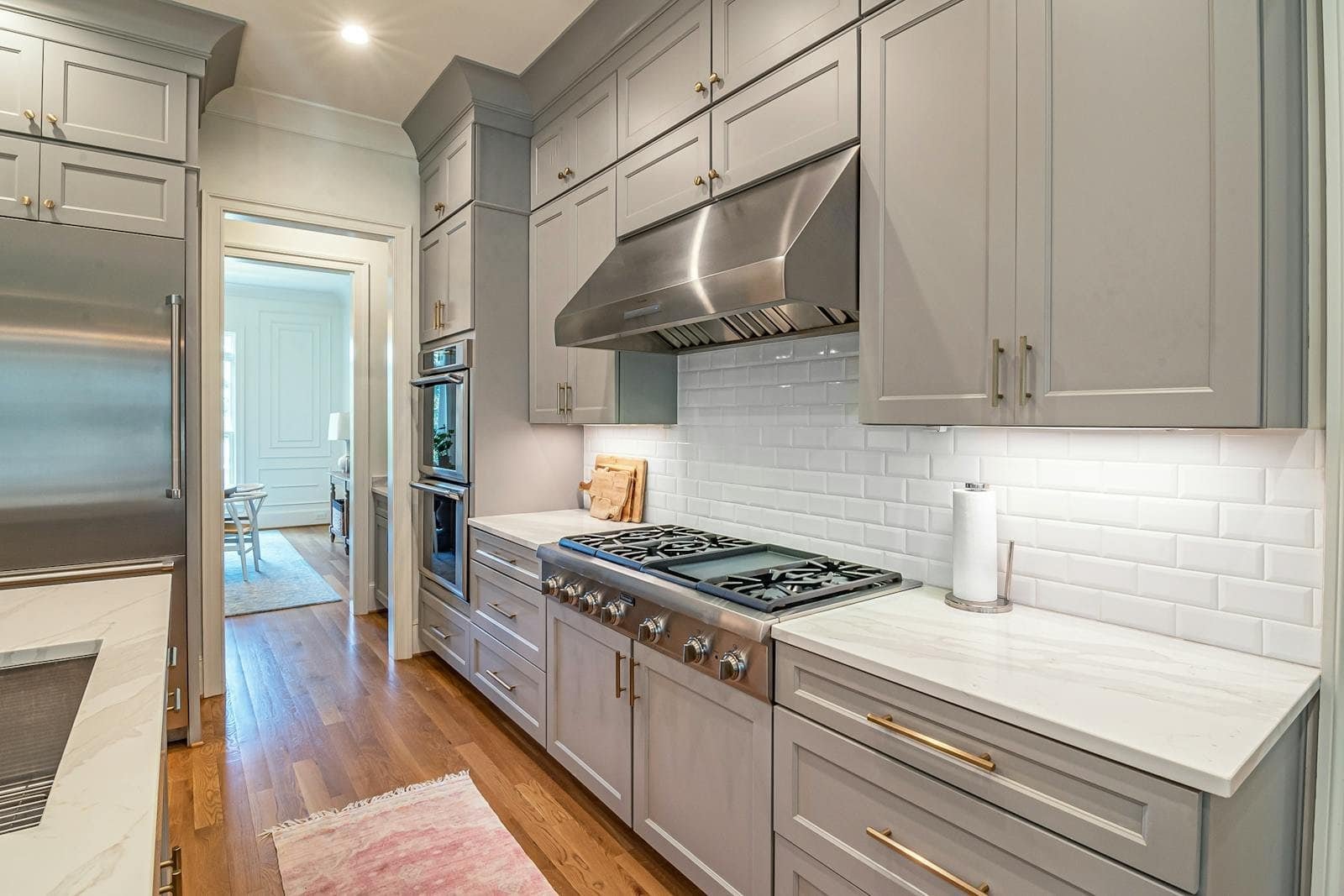 Renovated kitchen with white island and pendant lighting
