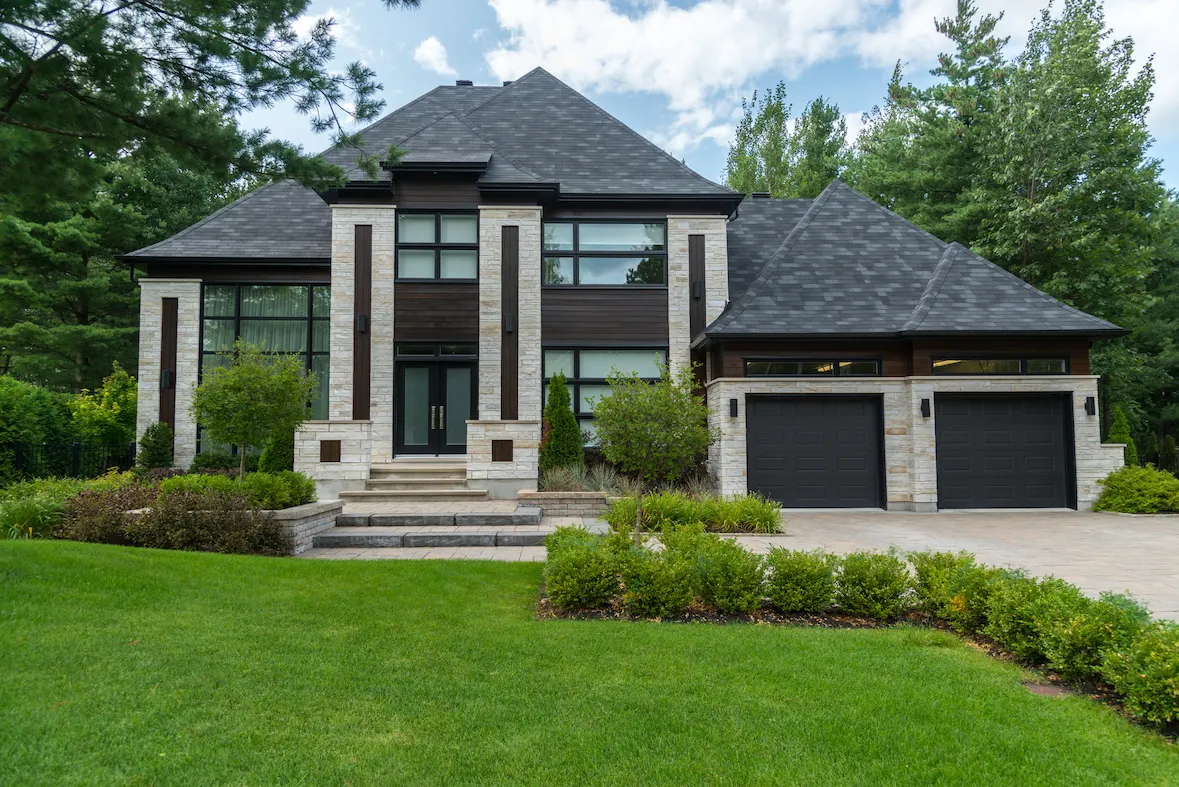 Modern custom home with stone and dark wood exterior built by Aloe Contracting in Barrie